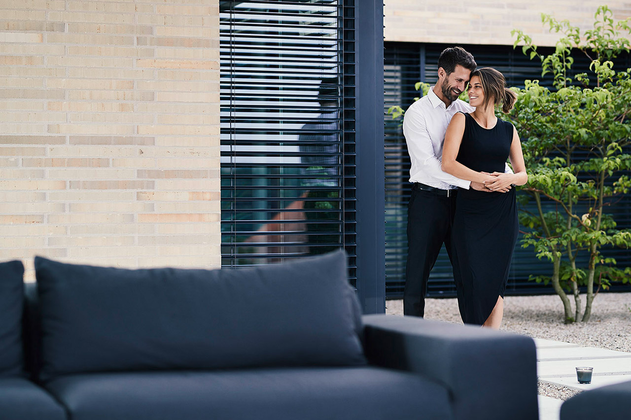 Mann und Frau stehen im garten und umarmen sich