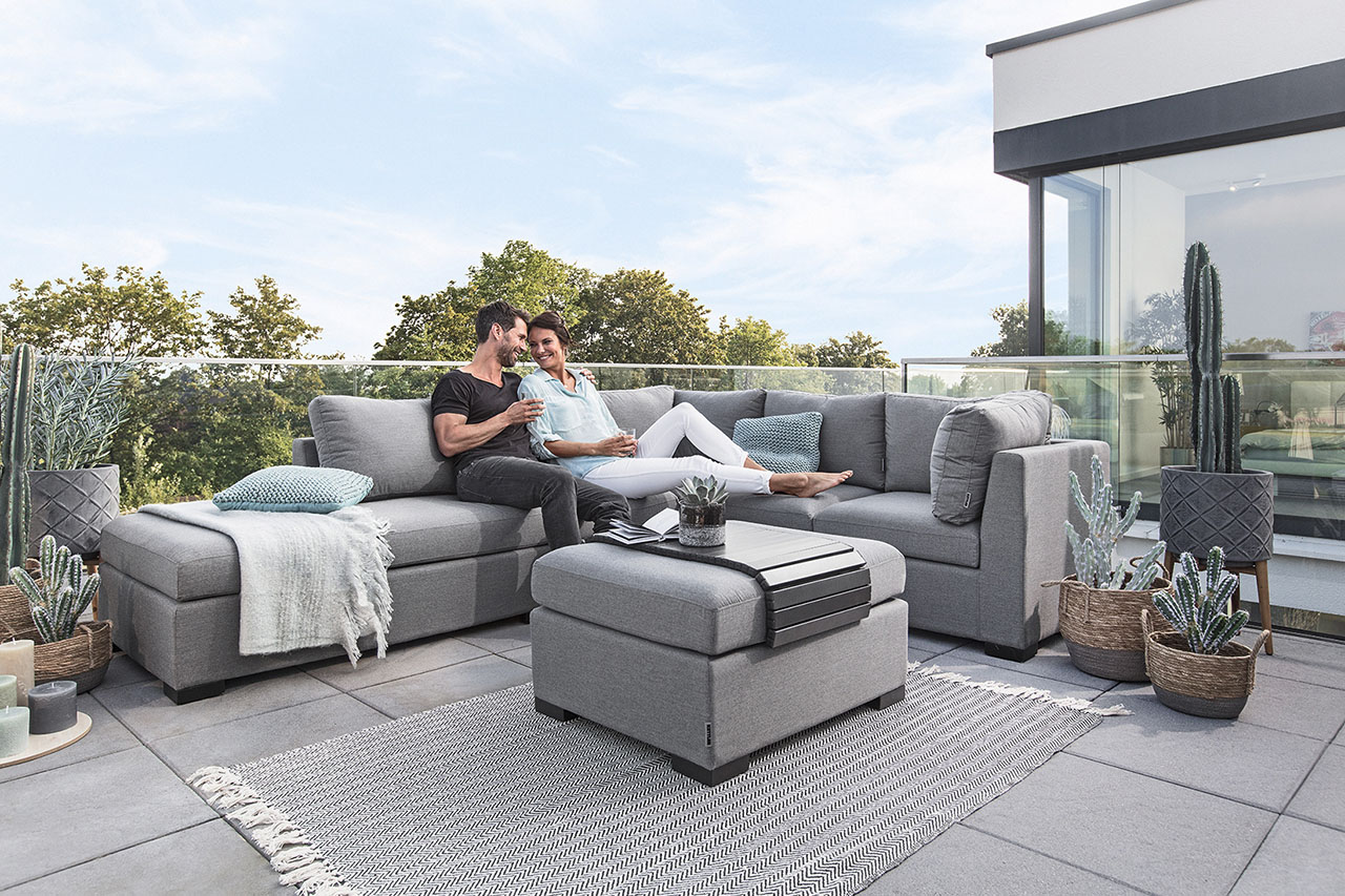 Mann und Frau siten auf dem Sofa auf der Terrasse